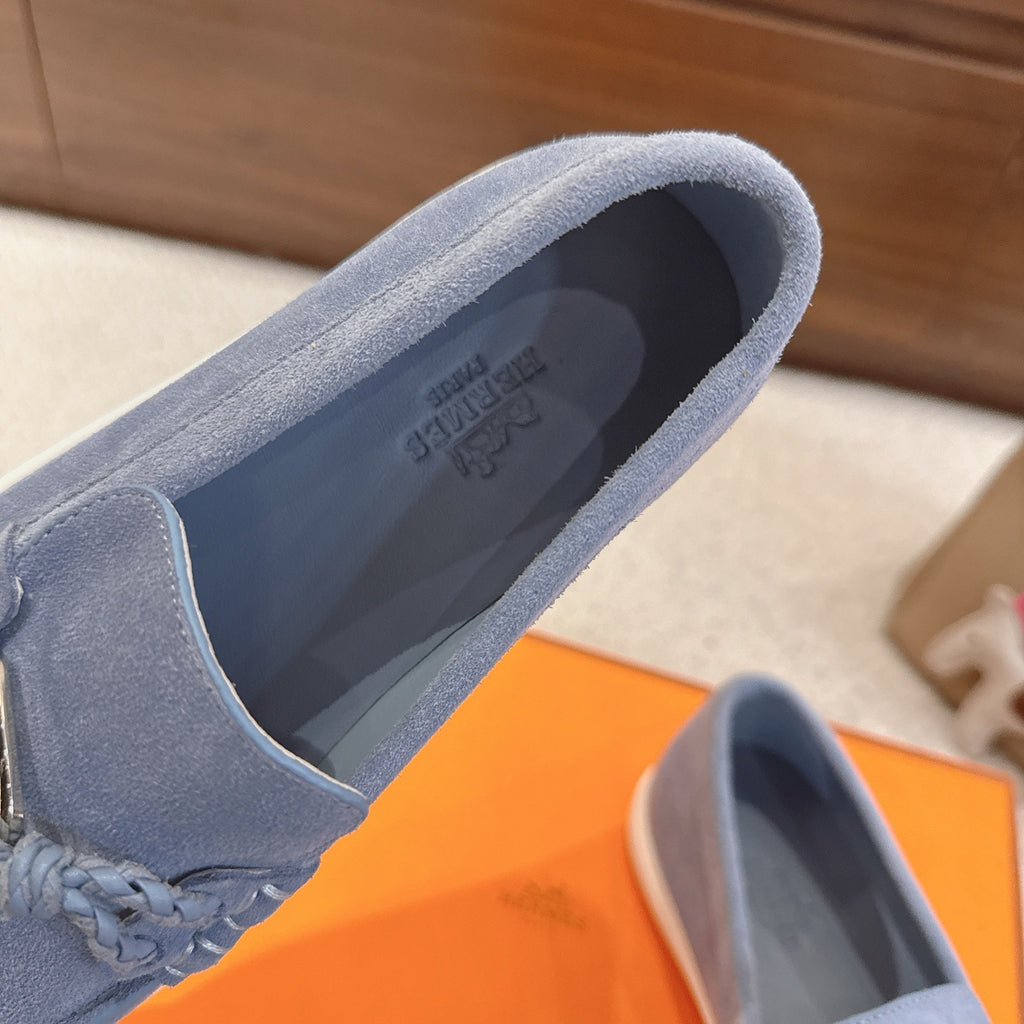 Blue suede loafer showing inner lining and padded collar opening