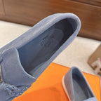 Blue suede loafer showing inner lining and padded collar opening