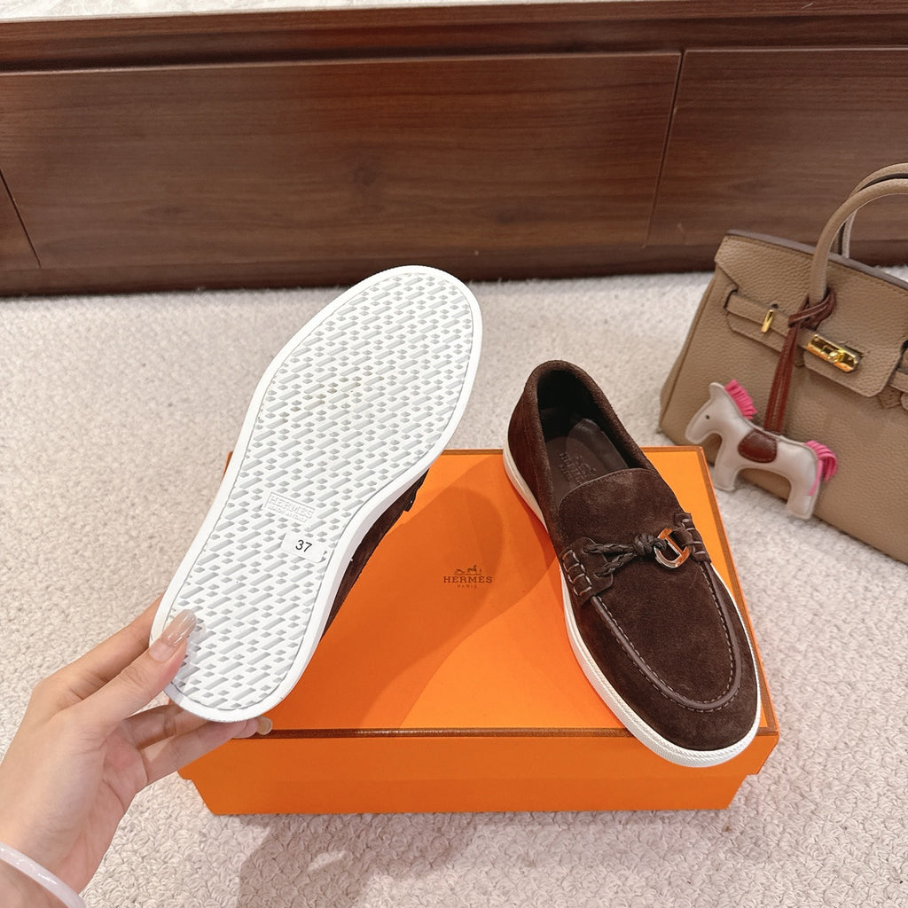 Hermes unisex suede loafers with white textured outsole and dark brown upper