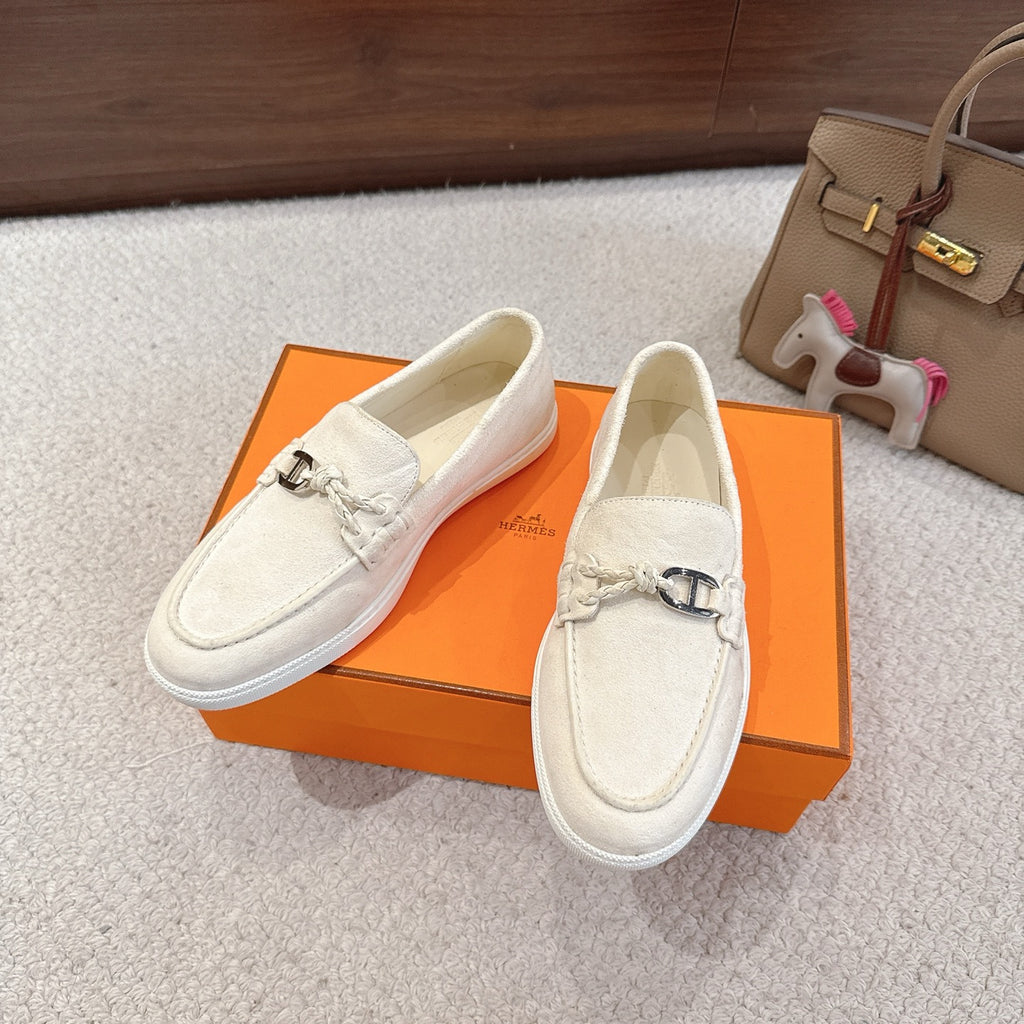 Hermes unisex white suede loafers on box, metal horsebit detail and textured outsole