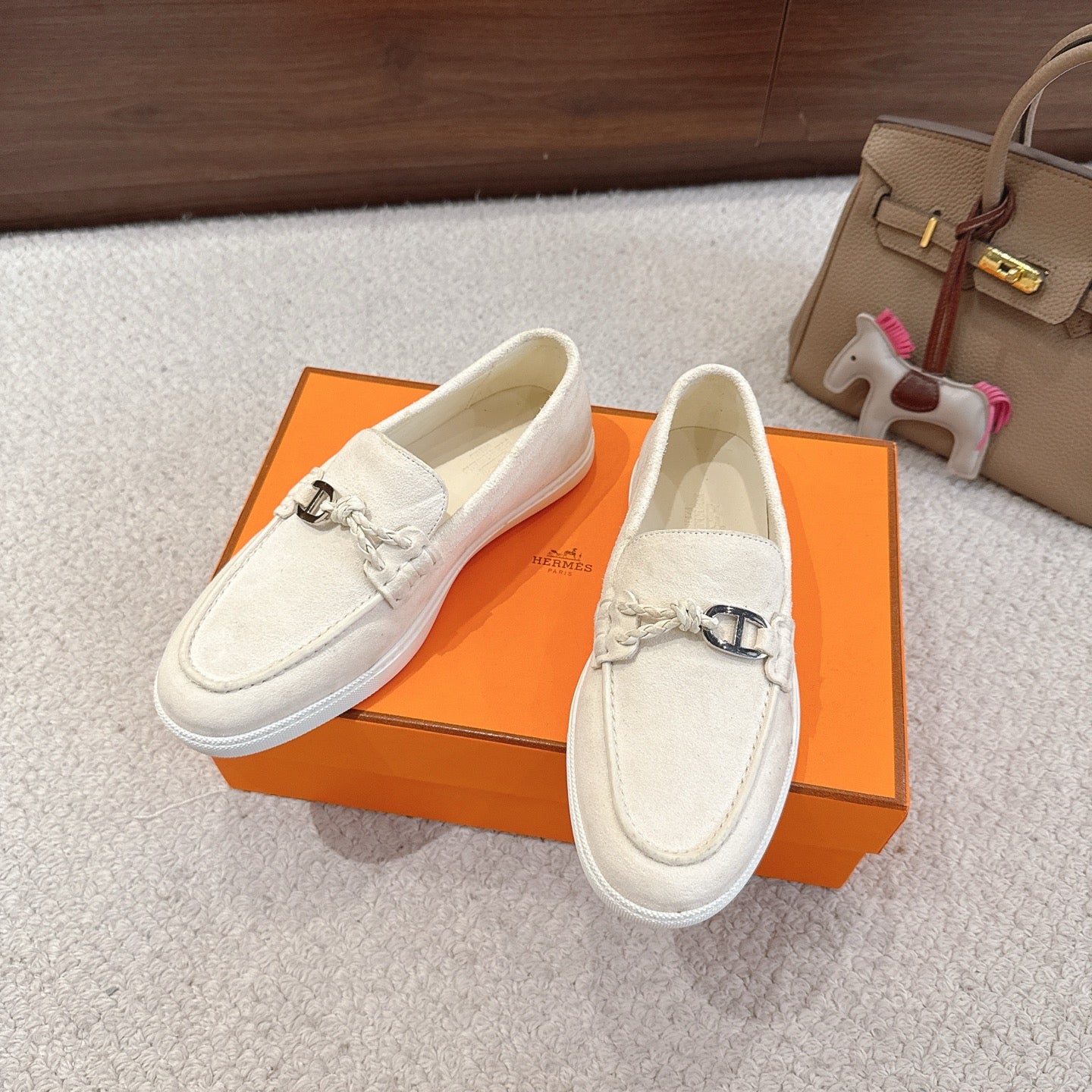 Hermes unisex white suede loafers on box, metal horsebit detail and textured outsole