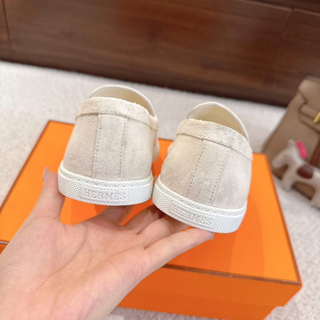 Hermes unisex white suede loafers, back view with branded heel panel and stitching