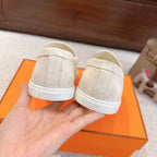 Hermes unisex white suede loafers, back view with branded heel panel and stitching
