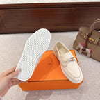 Hermes unisex white suede loafers, outsole view with textured tread pattern and size mark