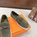 Hermes suede loafers, dark olive green, metal bit and braided laces; angled side view