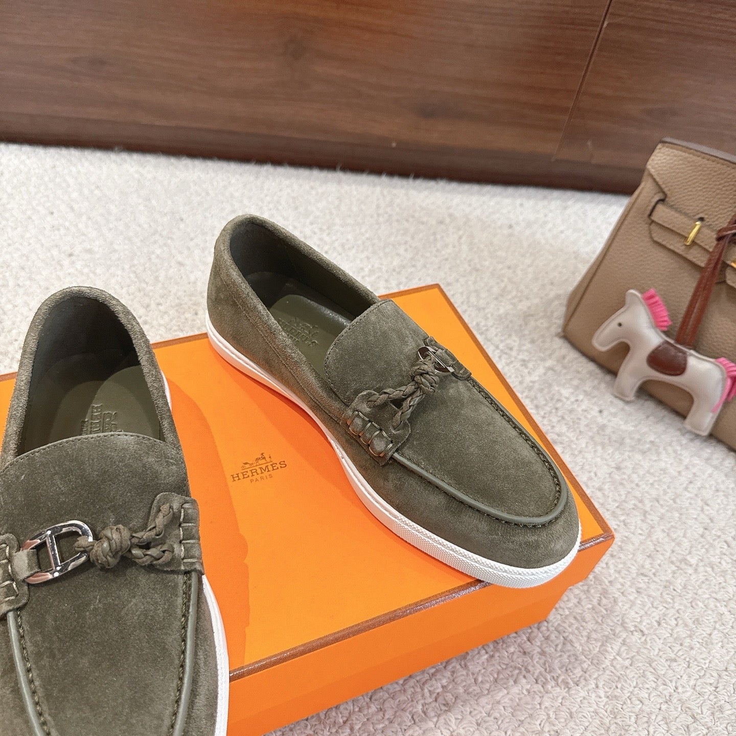 Hermes suede loafers, dark olive green, metal bit and braided laces; angled side view
