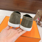 Hermes suede loafers, dark olive green heels with embossed Hermes logo on white strip