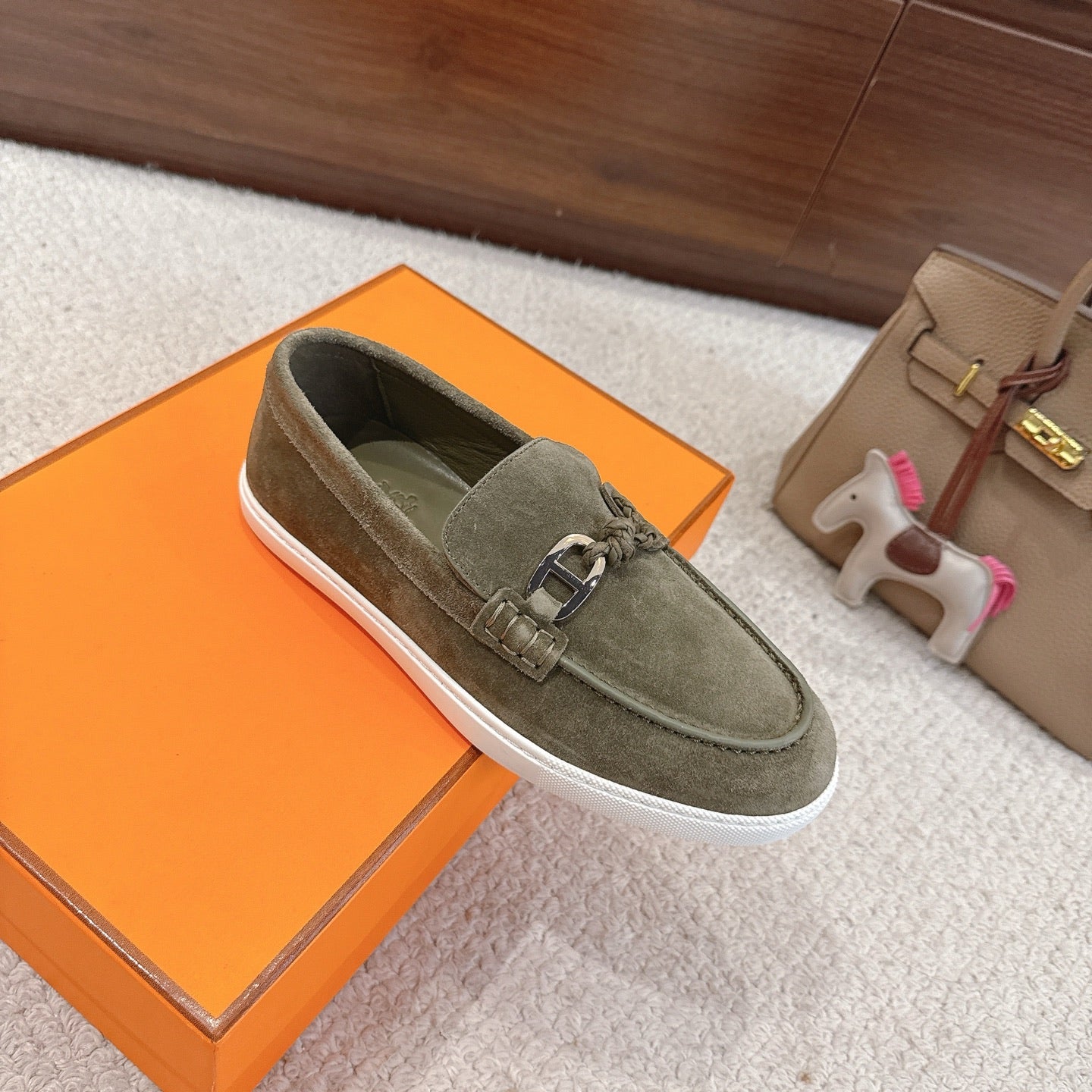 Hermes suede loafers in dark olive green with metal bit detail and white rubber trim