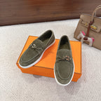 Pair of Hermes suede loafers in dark olive green with tassel laces and white rubber soles