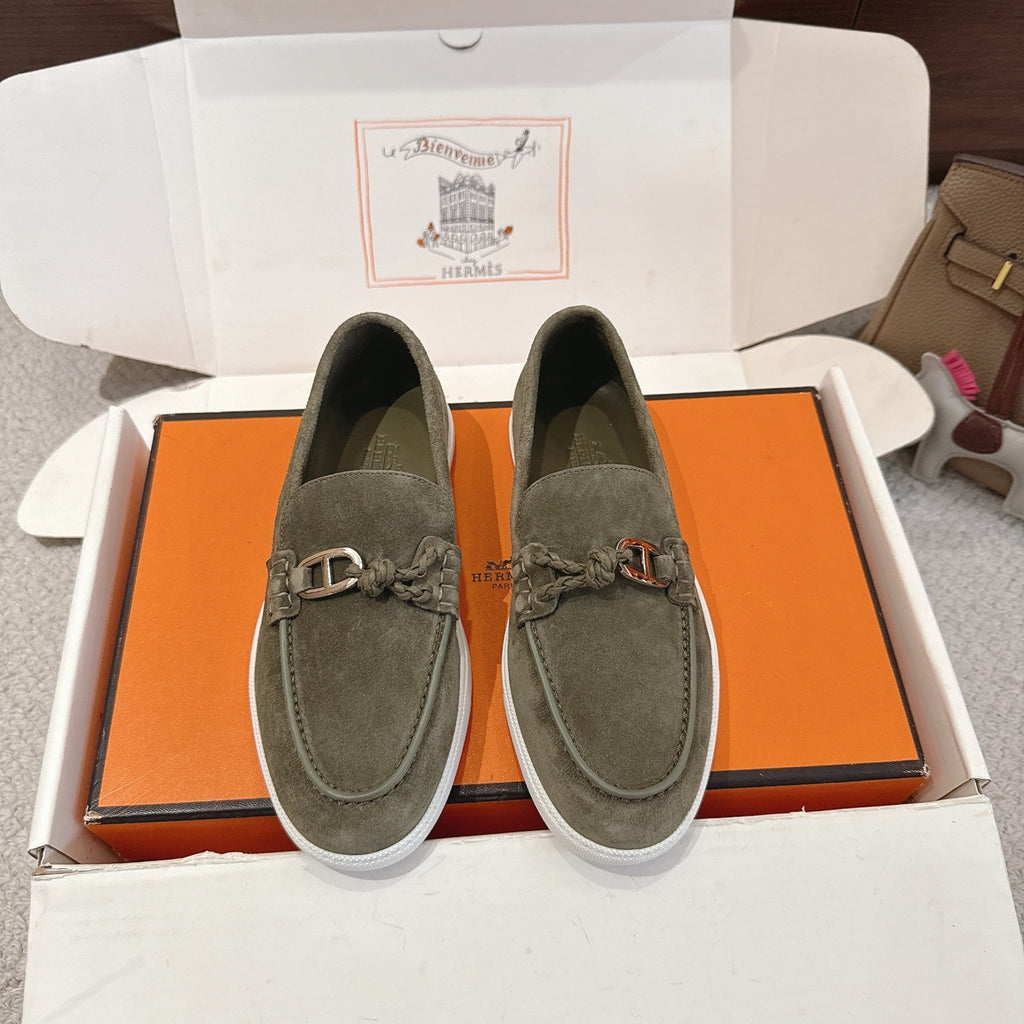Hermes suede loafers in dark olive green, lace-up detail and metal bit, white sole