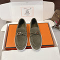 Hermes suede loafers in dark olive green, lace-up detail and metal bit, white sole