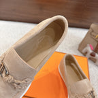 Hermes unisex suede loafers, beige close-up of suede upper and metal bit, white sole