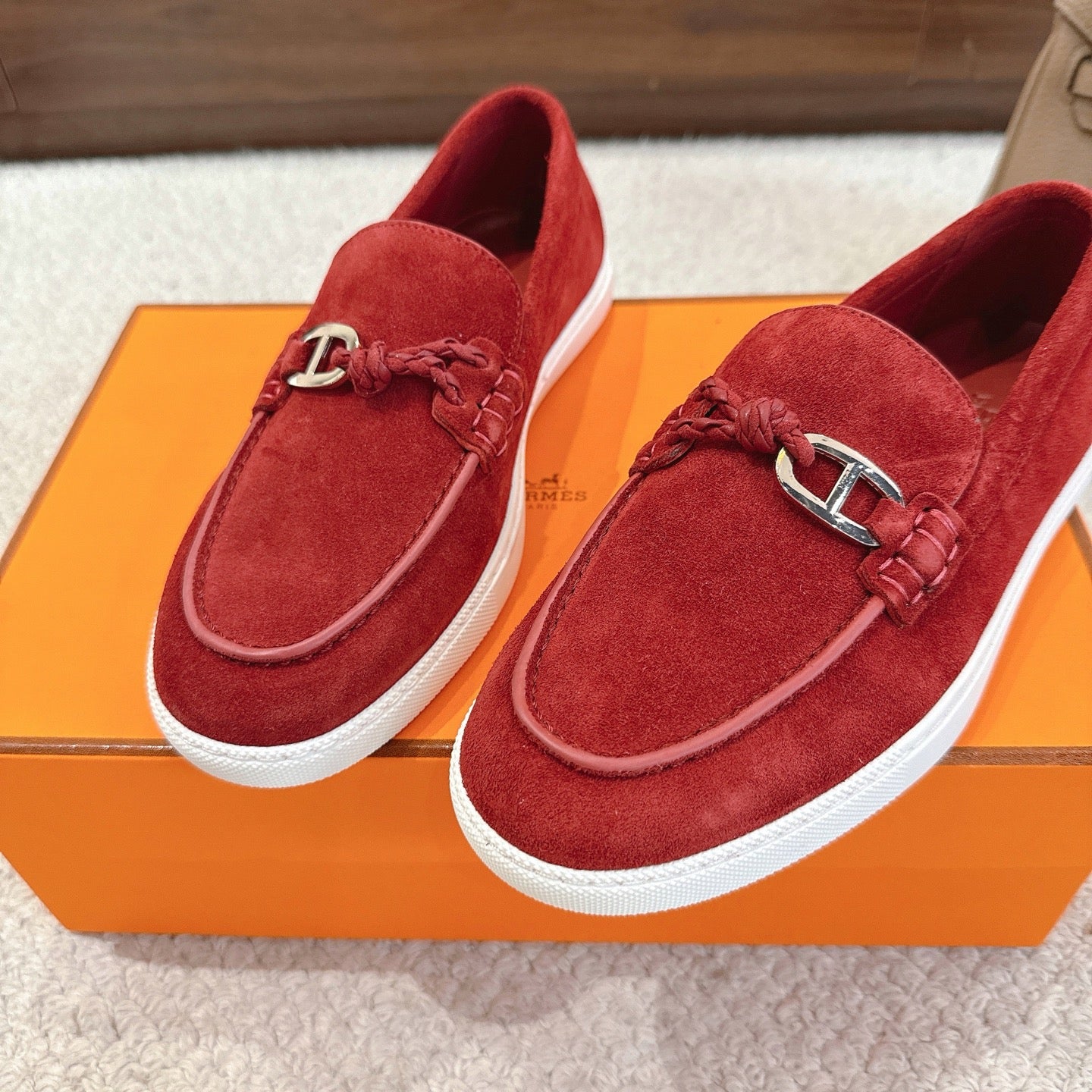 Hermes unisex red suede loafers, two angles, metal H bit detail, white sole