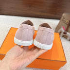 Hermes unisex light pink suede loafers, rear view with Hermes logo on white sole.