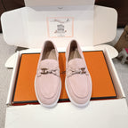 Hermes unisex suede loafers in light pink, silver-toned horsebit detail, white rubber sole.