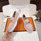 Hermes unisex light pink suede loafers with braided laces and silver-toned horsebit detail.