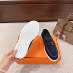Hermes unisex navy suede loafers, outsole view with textured tread and white trim