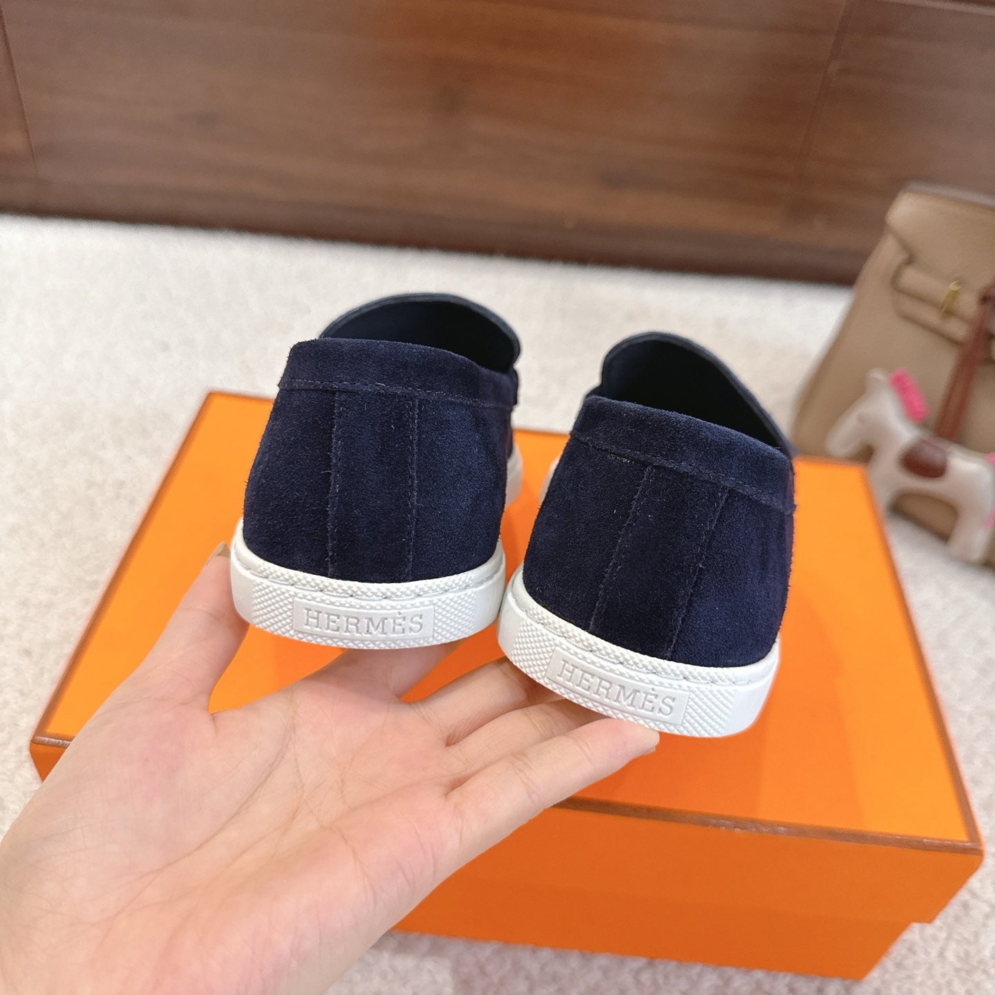 Hermes unisex navy suede loafers, back view with white cuff and embossed lettering