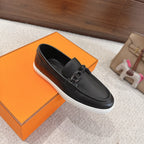 Hermes unisex dark leather loafer with metal buckle strap, moccasin stitching, white sole