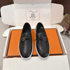 Hermes unisex loafers in dark leather with metal buckle detail and white rubber sole