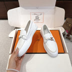 White leather loafers with metal horsebit strap and stitched vamp