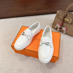 White leather loafer with metal horsebit accent, unisex slip-on style