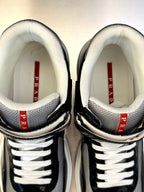 Prada unisex sneaker collar, white lining with red PRADA label, black leather edge