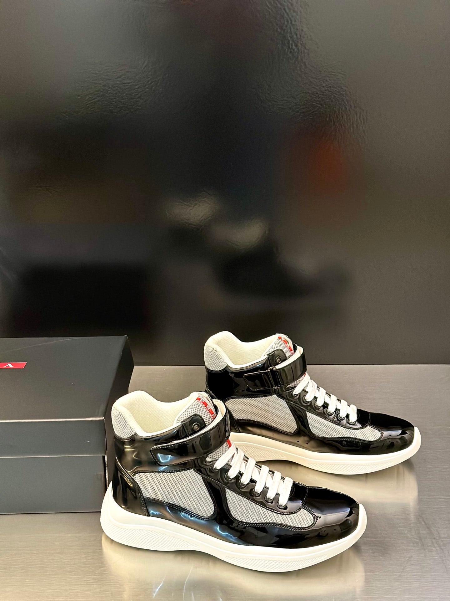 Prada unisex low-top sneakers, black glossy uppers, white midsoles, lace-up design