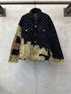 Long jacket with dark monogram pattern, gold buttons, and two-tone gold hem panel