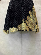 Long jacket back hem with dark monogram fabric and gold abstract paneling