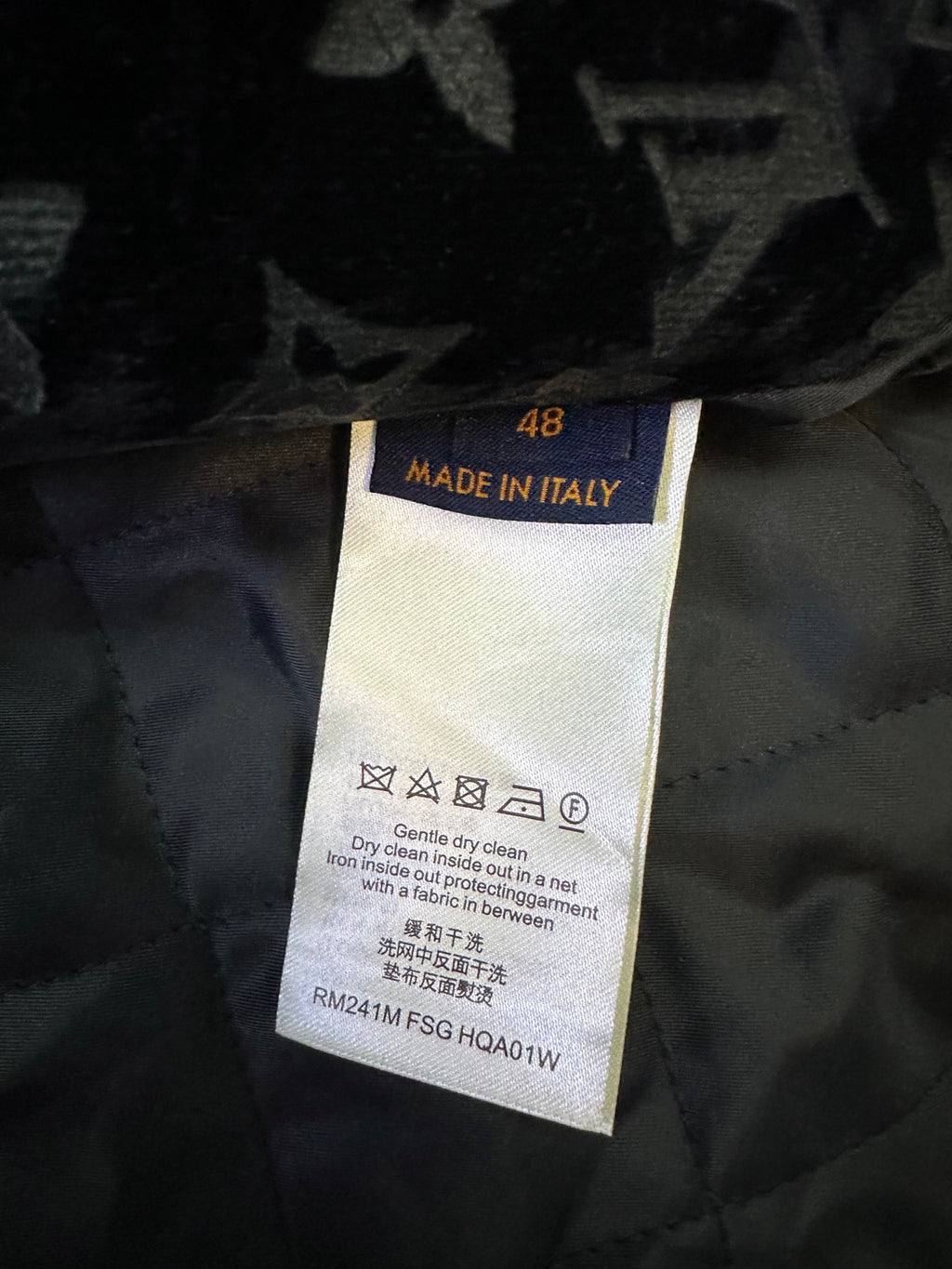 Garment care label showing 'Made in Italy' and drying or cleaning instructions