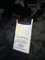 Garment care label showing 'Made in Italy' and drying or cleaning instructions