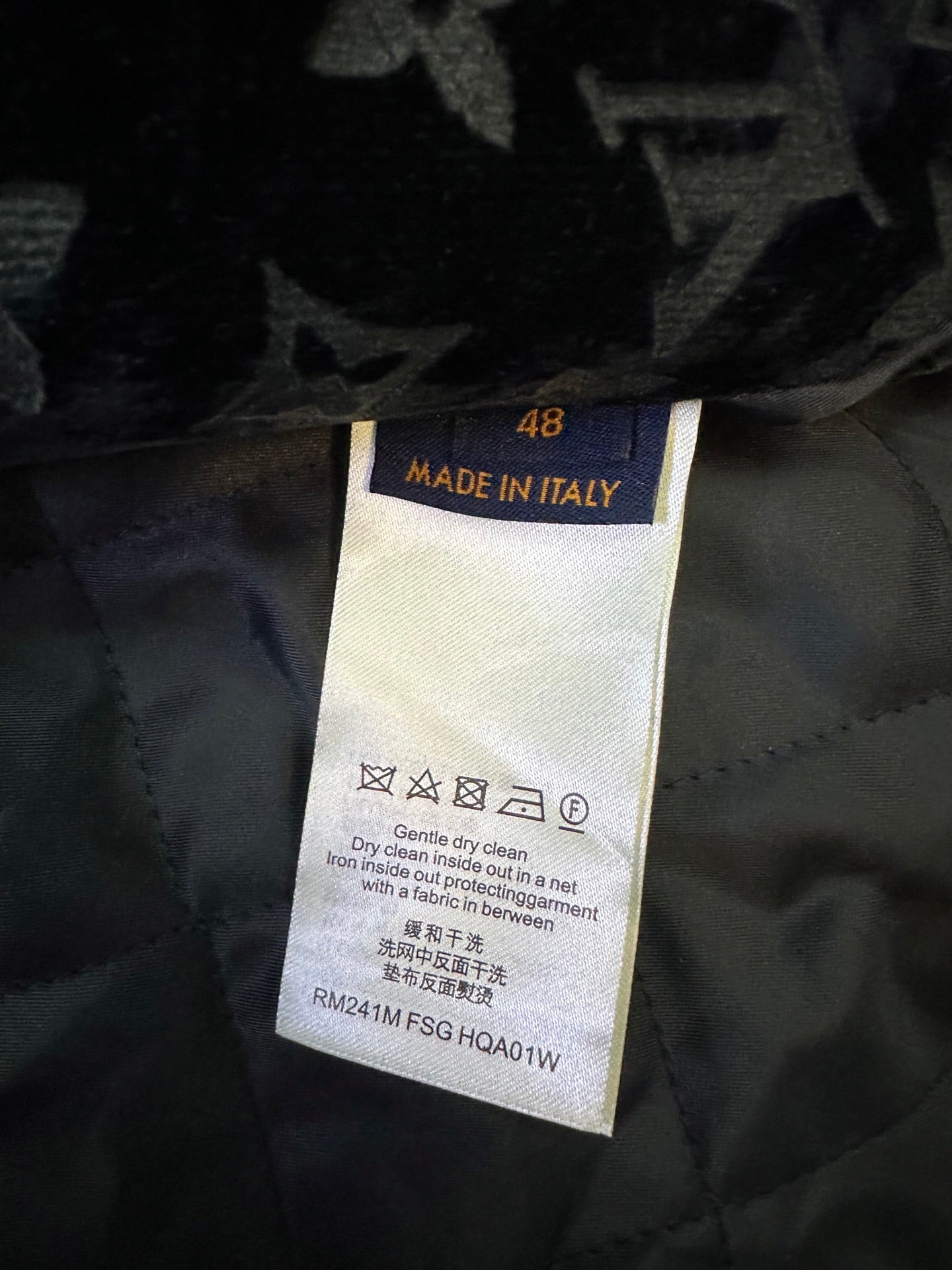 Garment care label showing 'Made in Italy' and drying or cleaning instructions