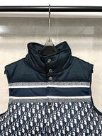 Sleeveless puffer vest with dark hooded collar and white logo stripe across chest