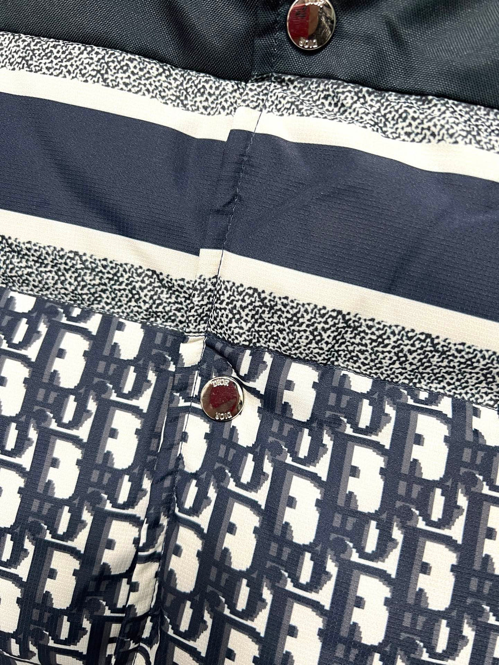 Puffer vest button placket with white stripe and logo print lower panel