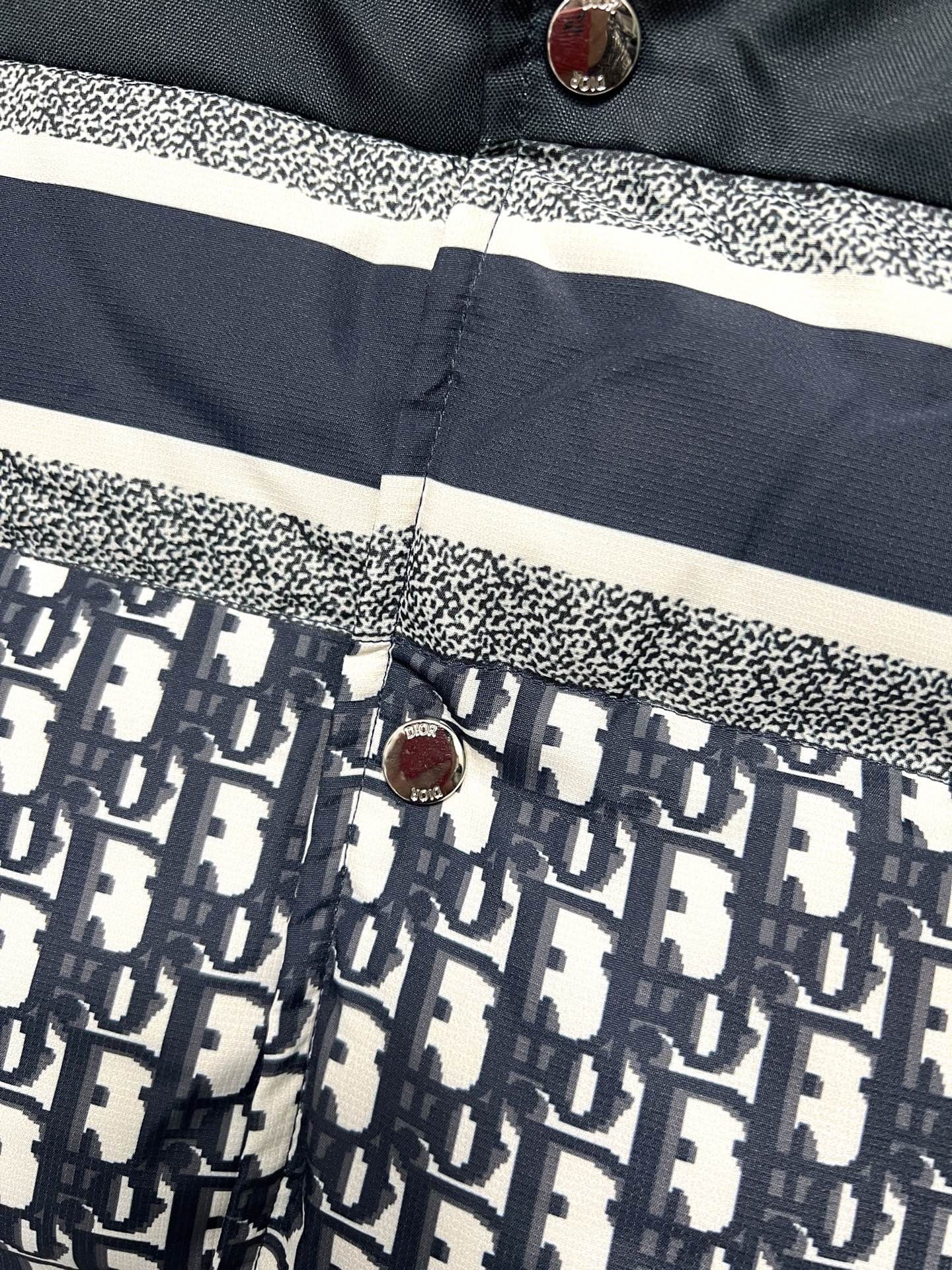 Puffer vest button placket with white stripe and logo print lower panel