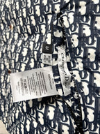 Puffer vest care label and size tag on logo-print fabric
