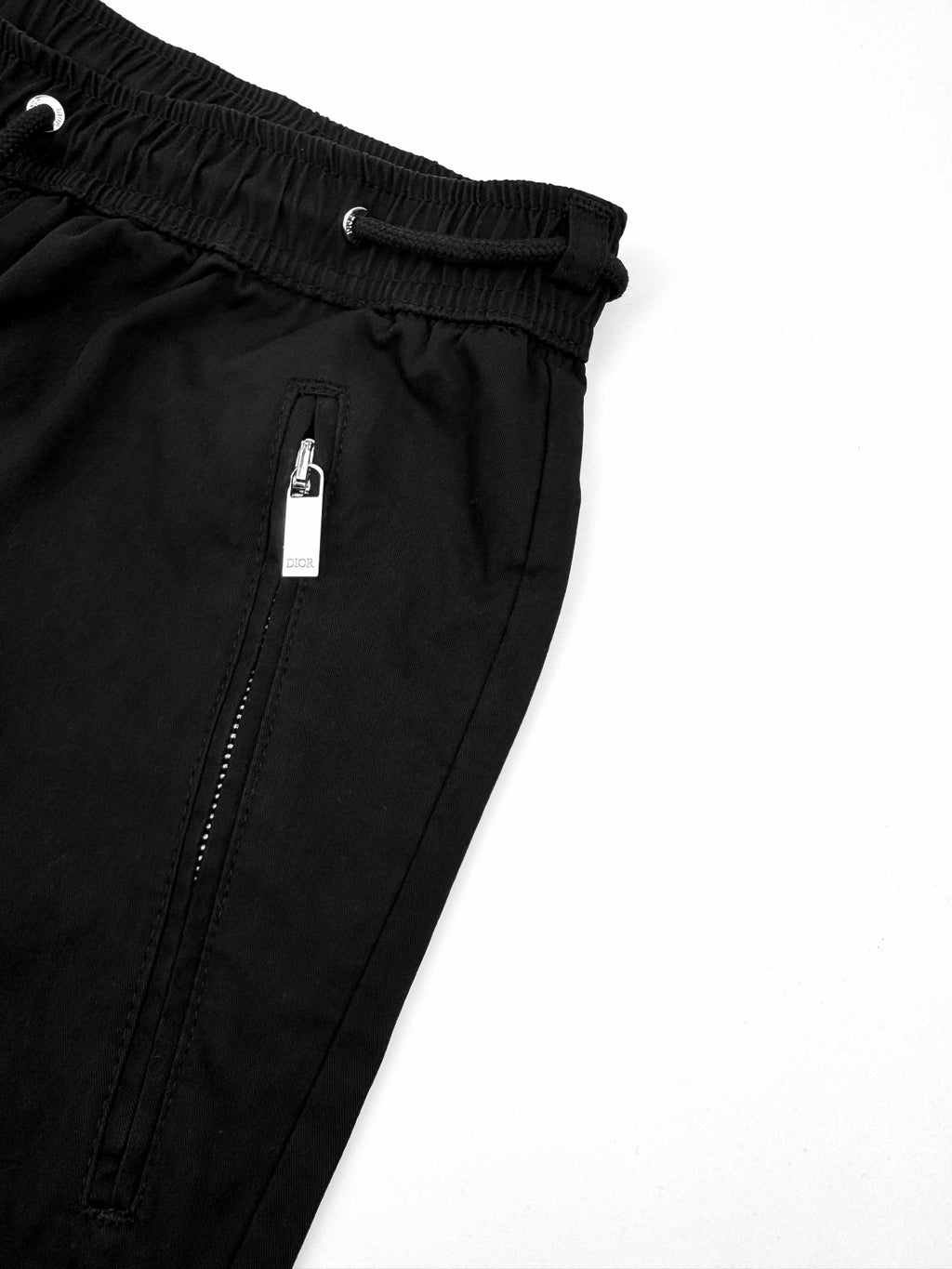 Black Dior pants with elastic waistband and front zip detail