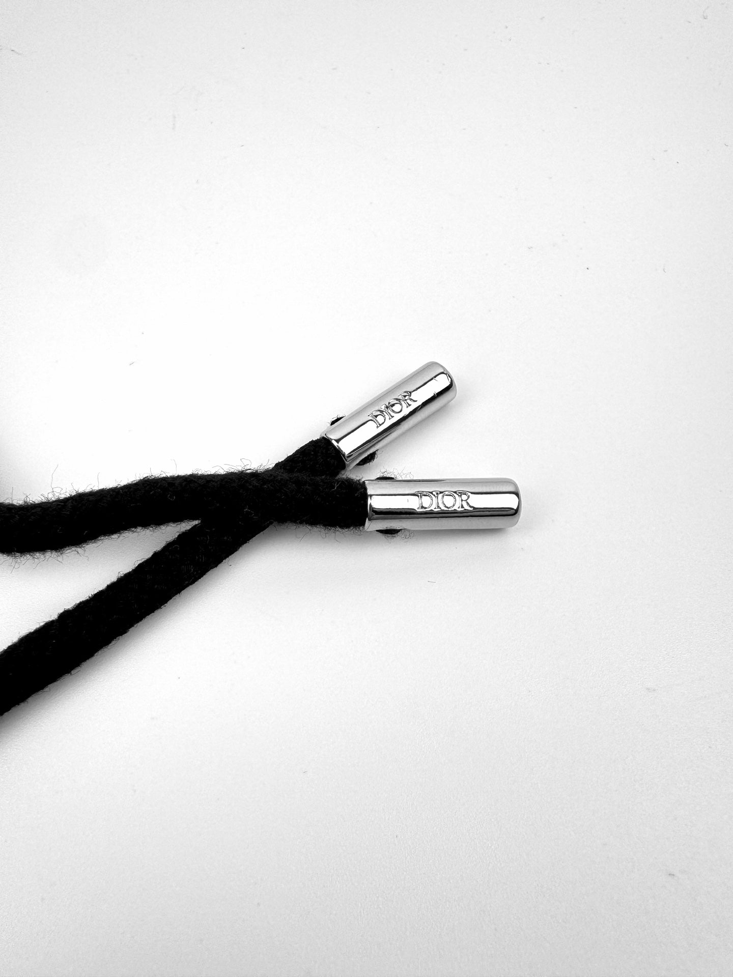Dior drawstring tips with metal toggles and Dior branding