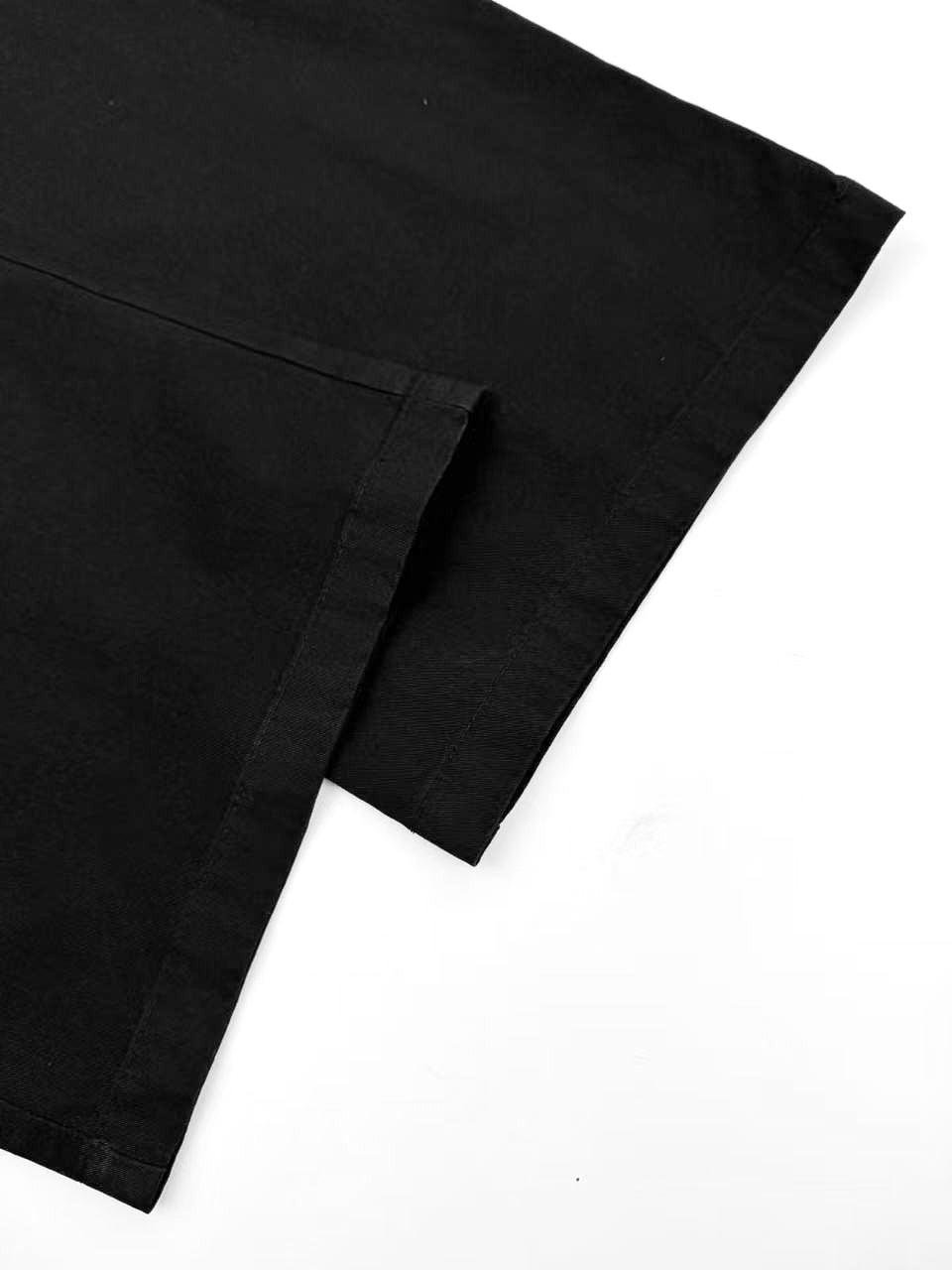 Black pants hem and side seam detail