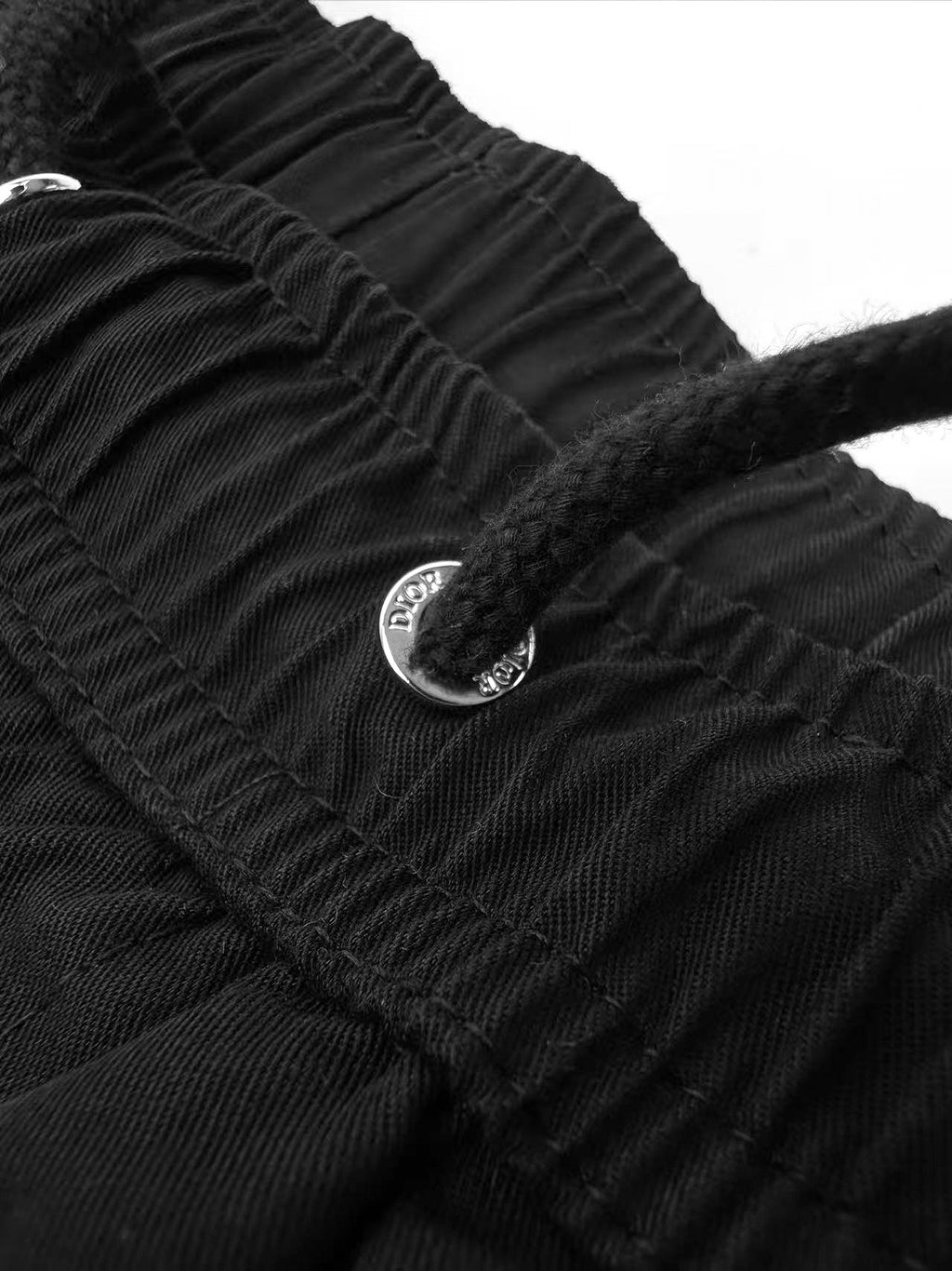 Black Dior pants with button detail on ruched waistband