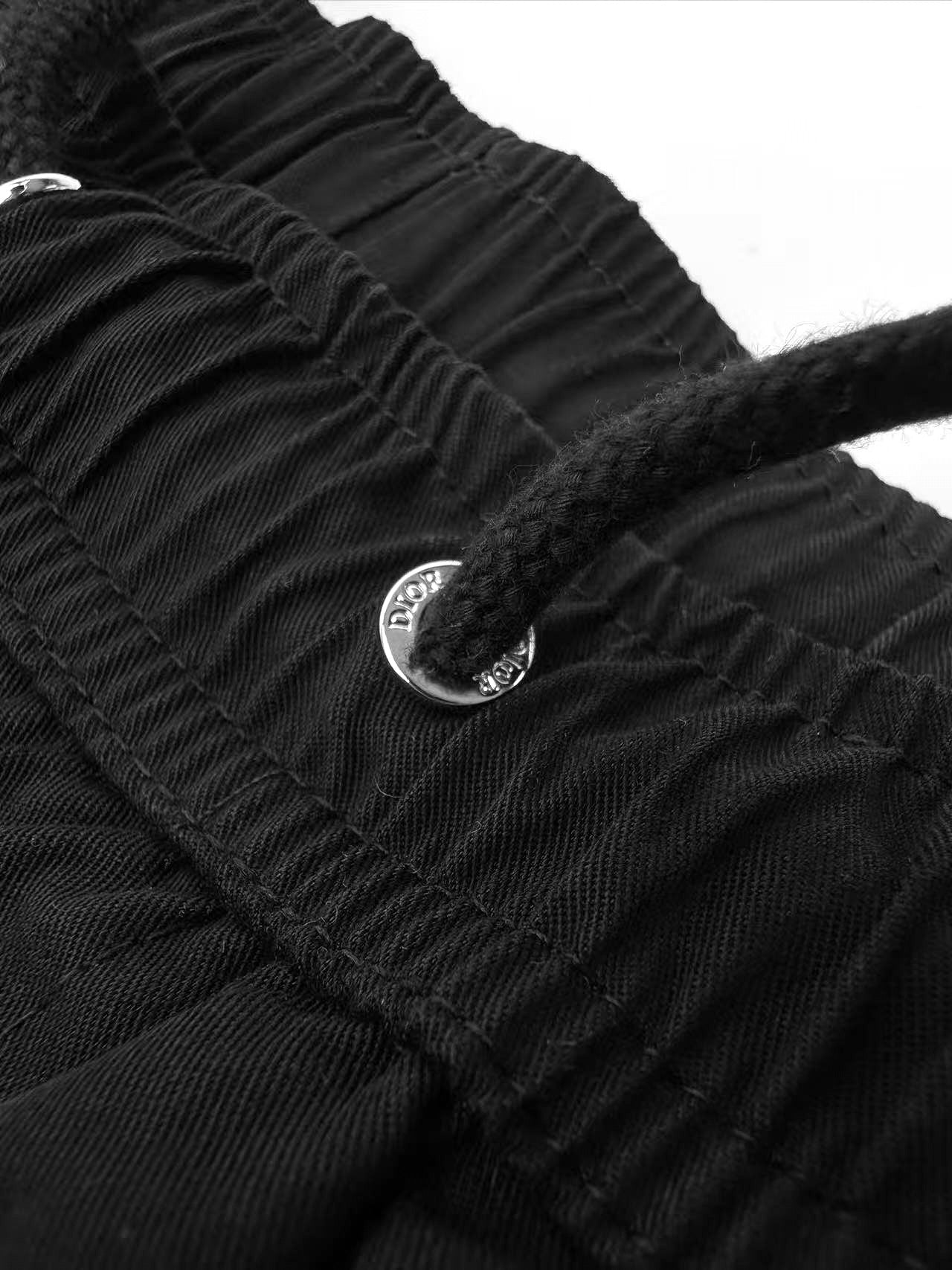 Black Dior pants with button detail on ruched waistband