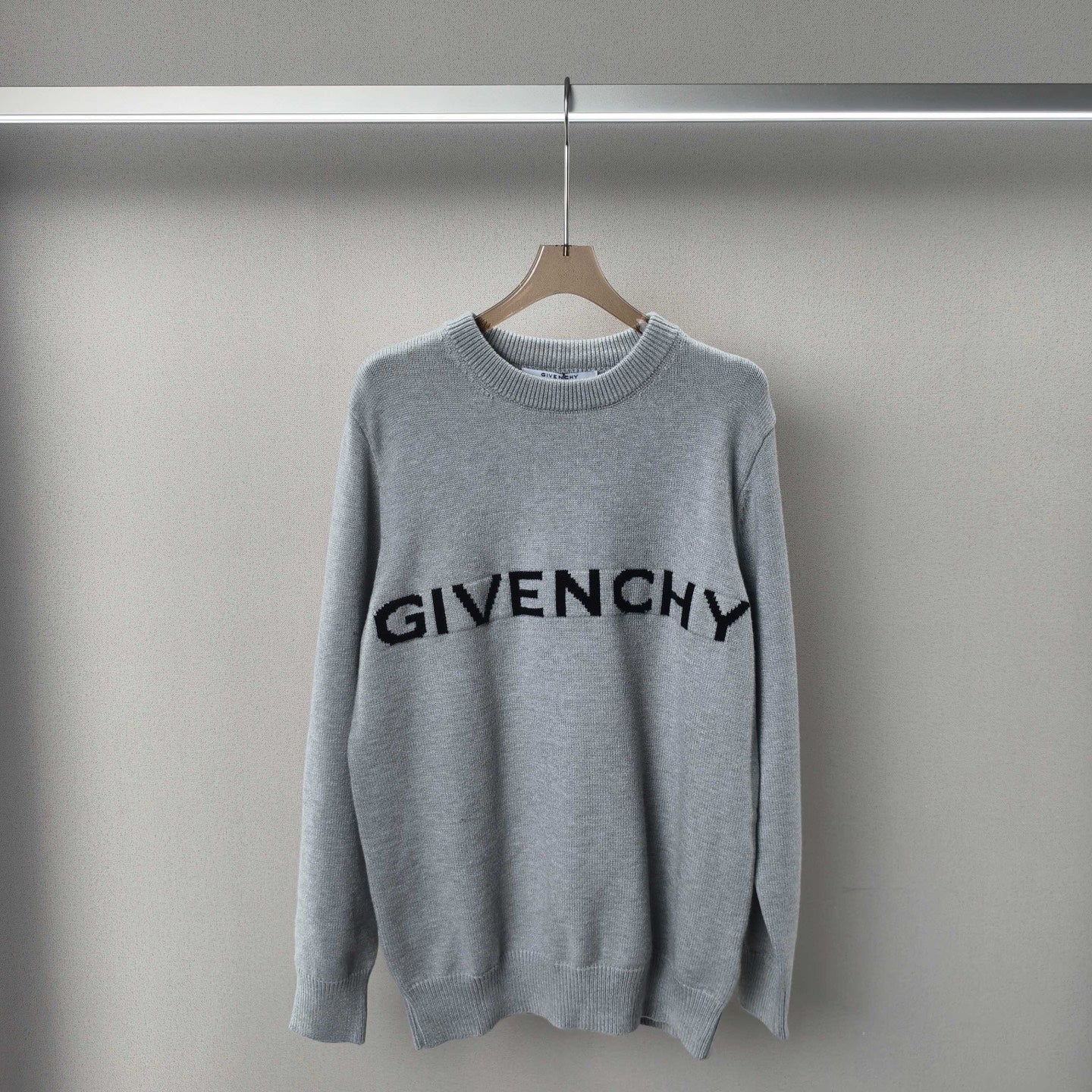 Light grey knit crewneck sweater with black GIVENCHY logo on chest