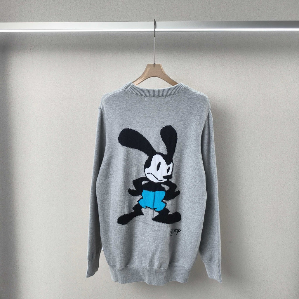 Light blue crewneck knit sweater with cartoon graphic on front