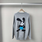 Light blue crewneck knit sweater with cartoon graphic on front