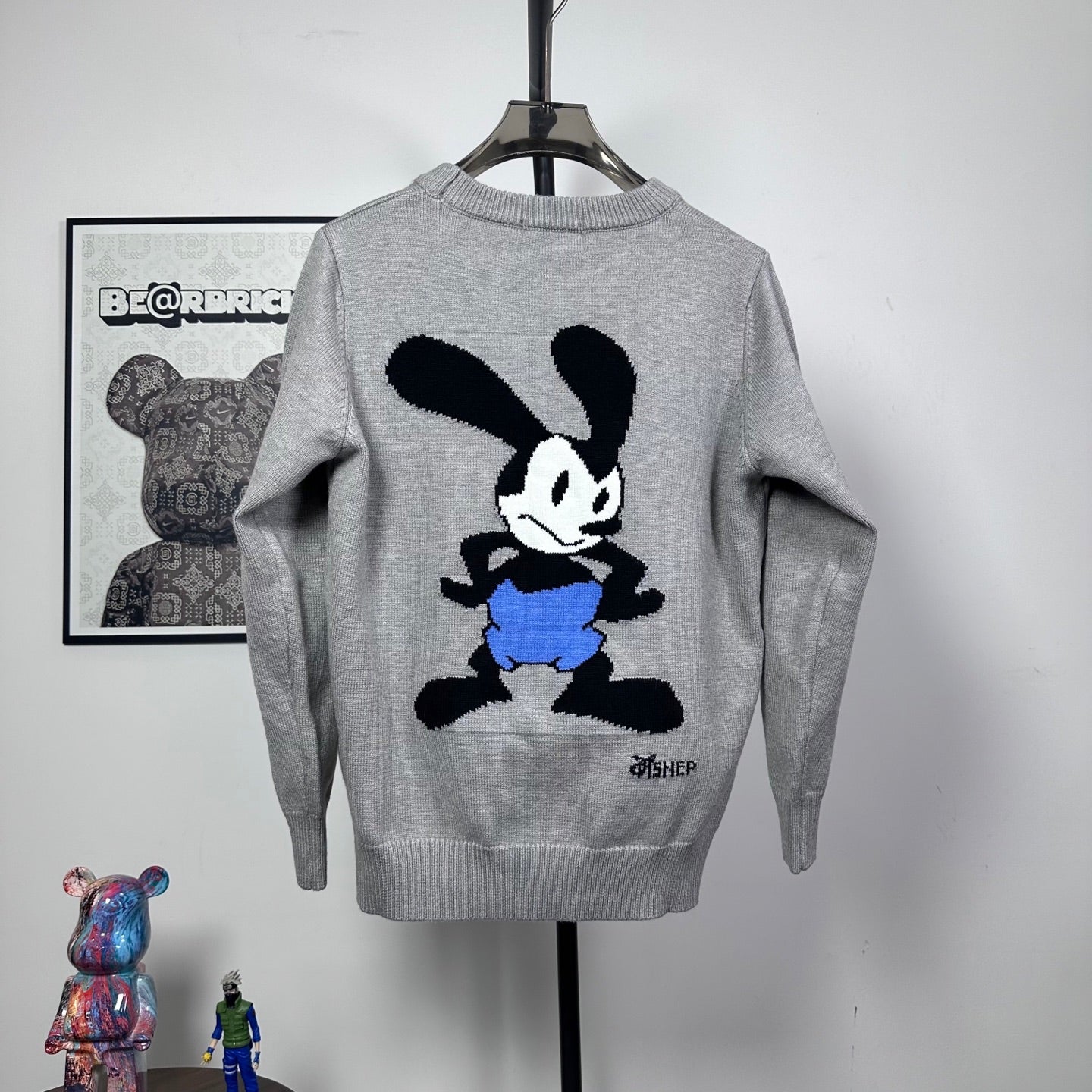 Grey knit crewneck sweater with Mickey Mouse graphic and blue shorts