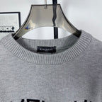 Grey knit crewneck collar with ribbed trim and black inner label