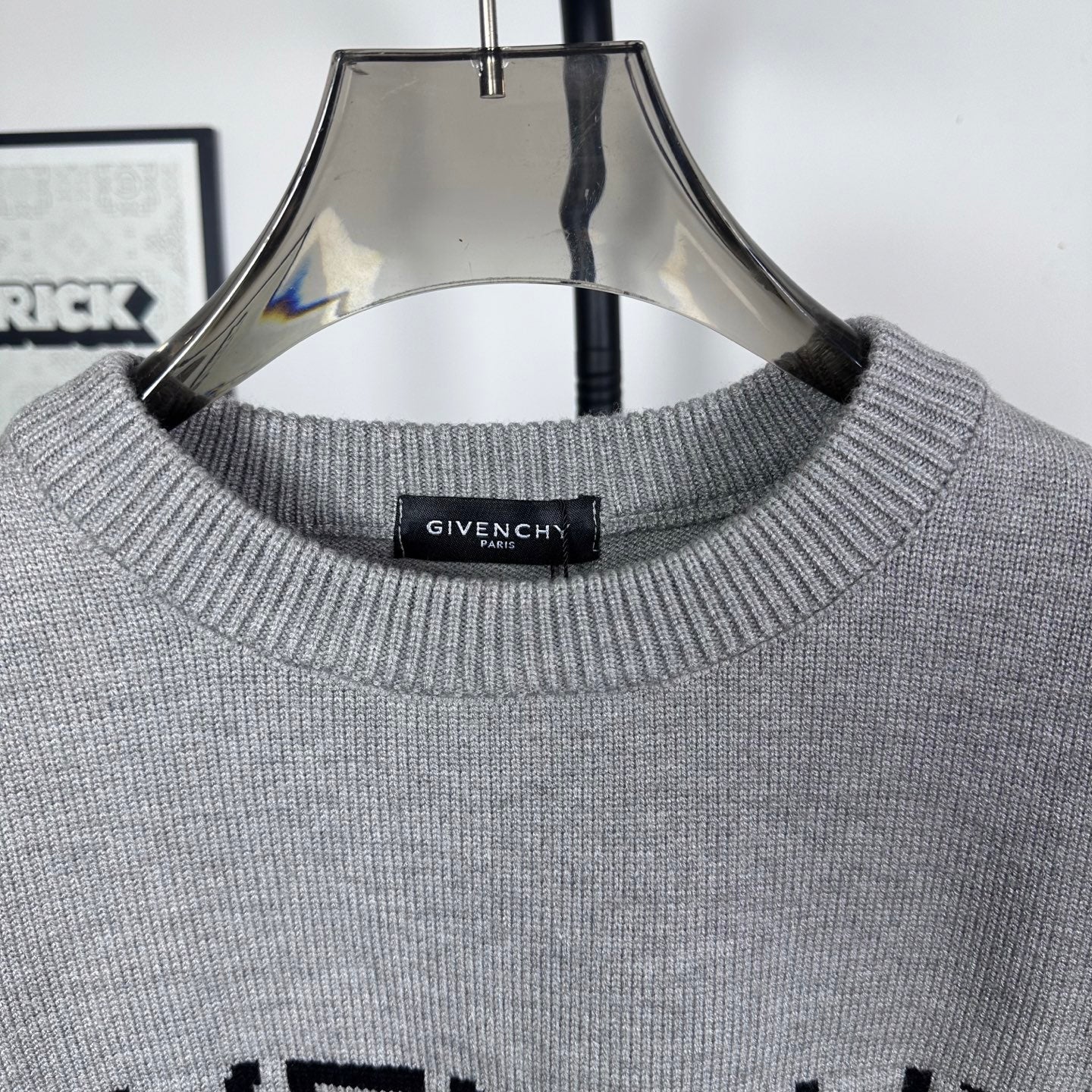 Grey knit crewneck collar with ribbed trim and black inner label