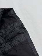 Dior long puffer jacket side panel close-up with dark monogram pattern and stitching