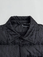 Dior long puffer jacket close-up at stand collar with dark monogram fabric